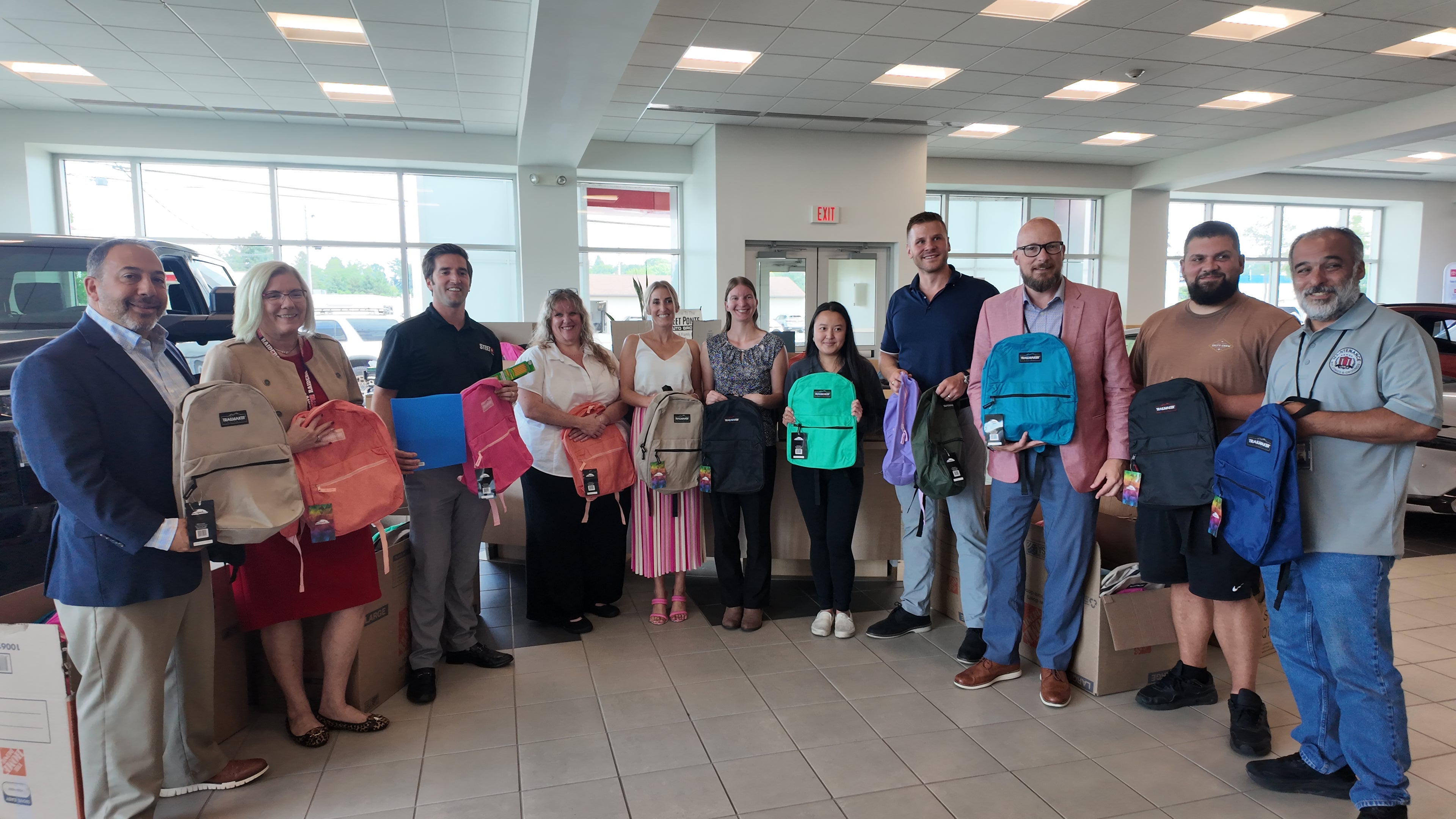 Steet Ponte Auto Group Presenting Utica City School District Representatives with Backpacks